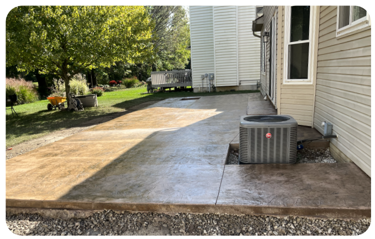 Sealed concrete patio next to a home in Columbus, providing long-term protection, enhanced appearance, and reduced maintenance.