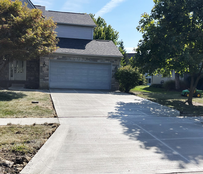 New driveway construction in concrete leading to home owners garage